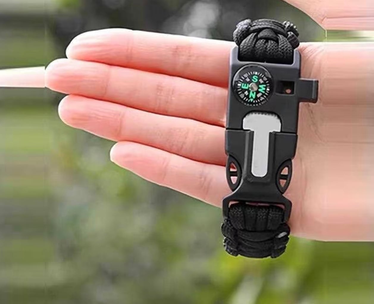 Paracord tactical bracelet on hand — real catalog photo; custom bead and Daoist strands follow the same QC path.